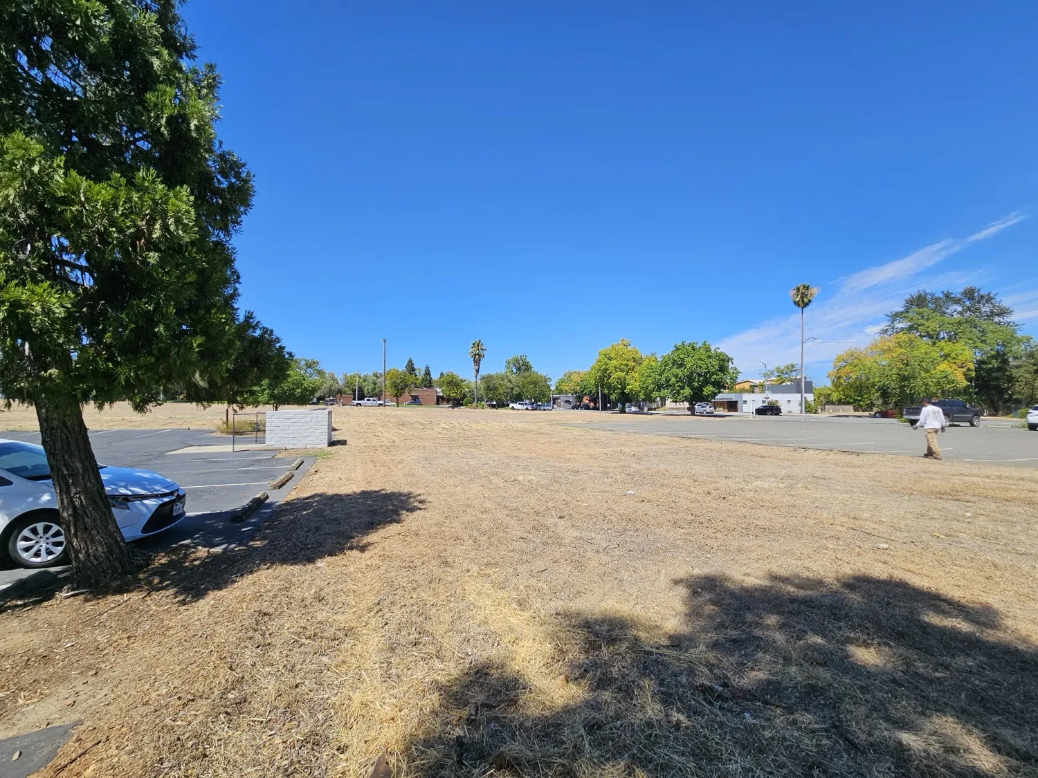 Corner commercial lot cut down with the business district behind it