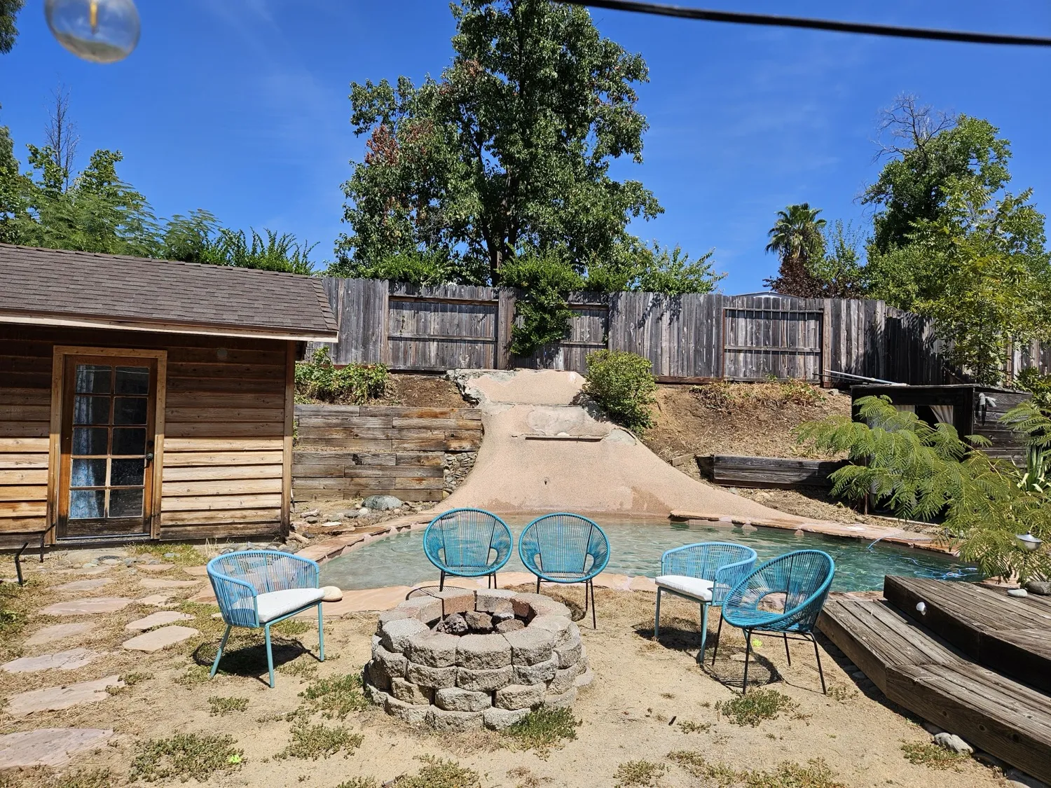 Backyard pool area with the surrounding ground cleaned up